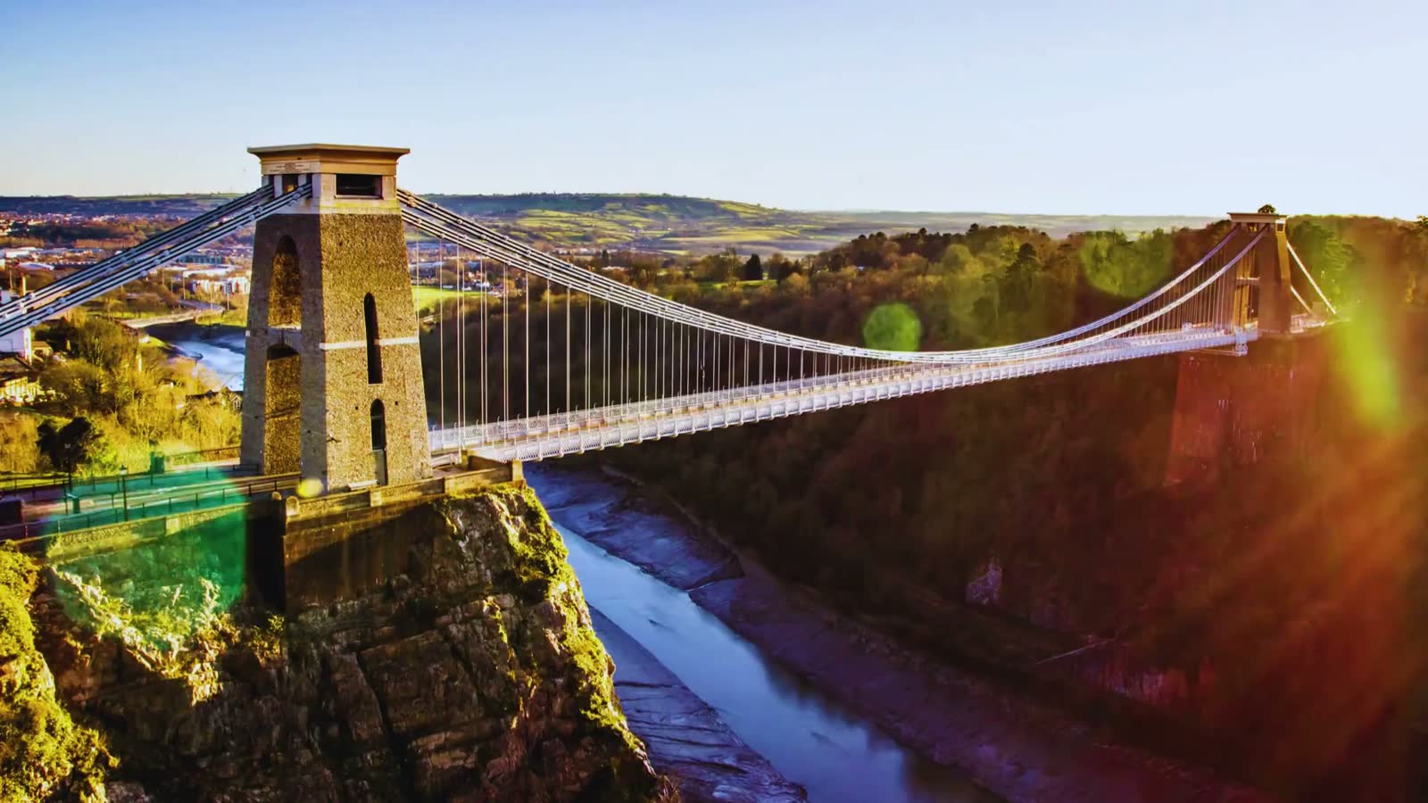The Clifton Suspension Bridge spanning the Avon Gorge in Bristol, from daylight through dusk to night